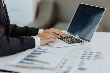 Businessman's hands with laptop computer, data document, company budget Marketing analysis Business accounting concept. Businessman