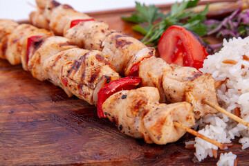 Close up chicken skewers on wooden board