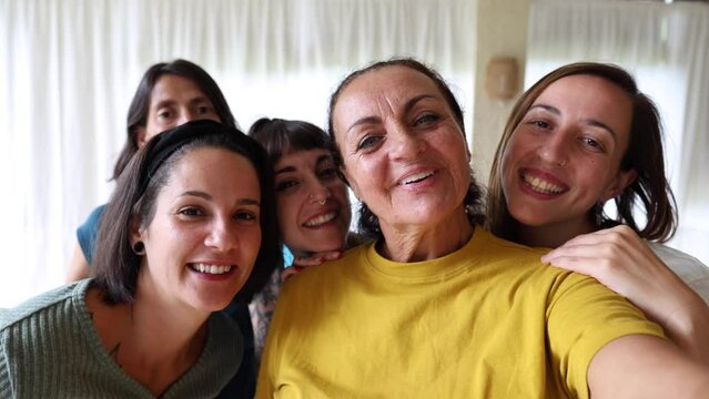 group of multigenerational female friends taking selfie with phone camera - Multiracial friends of different ages having fun together