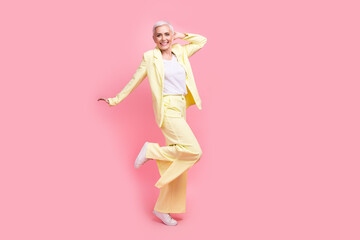 Fototapeta na wymiar Full body photo of funky optimistic nice person dressed yellow jacket trousers dancing having fun isolated on pink color background