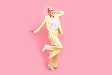 Full body photo of funky optimistic nice person dressed yellow jacket trousers dancing having fun isolated on pink color background