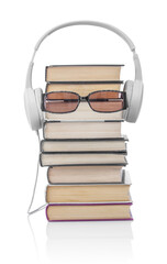 Headphones, eyeglasses and stack of books on a white background. Audio book concept