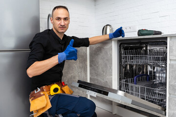 Fototapeta premium Dishwasher Appliance Repair Service. Household Maintenance Repairman