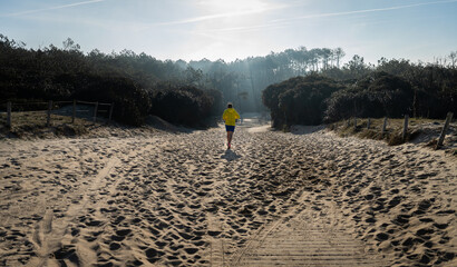 person walking in the beach