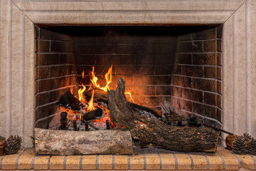Glowing fire in a huge stone fireplace.