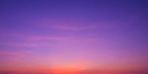 Colorful romantic twilight sky with beautiful pink sunset cloud and orange sunlight on dark blue...
