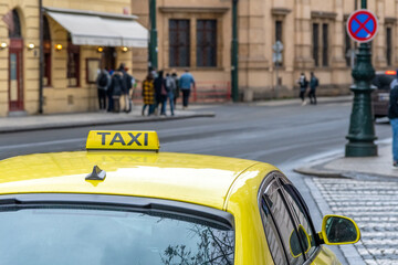 Details of yellow taxi car on the city street.