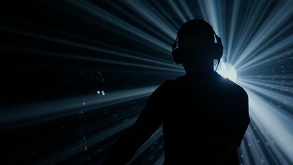 Silhouette of a DJ at Club Event with Stage Lights