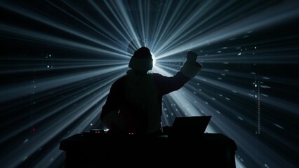 Silhouette of a DJ at Club Event with Stage Lights