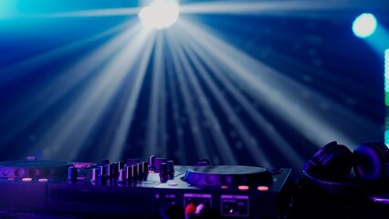 Fototapeta na wymiar DJ Setup with Vibrant Light Show in Club Atmosphere