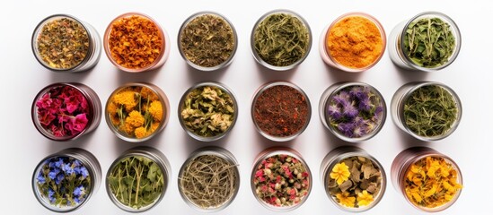 Arrangement of dried healing herbs in containers, from a top perspective.