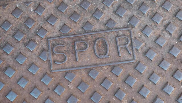 Metal manhole with spqr latin text in Rome 