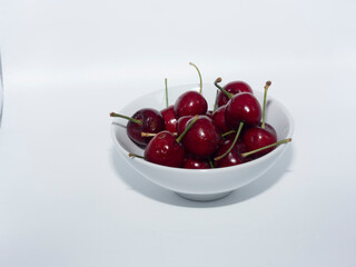 Cherries in a White Bowl on a white background