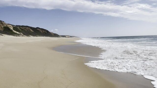 Calming waves breaking on an empty beautiful beach on the Alentejo Coast, Portugal, Europe