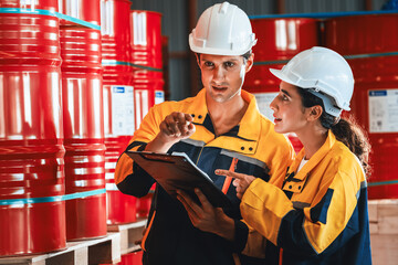 Two factory workers or inventory inspector conduct professional inspection on hazardous chemical...