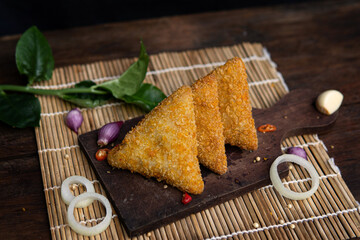 risoles filled with chicken, indonesian food, coating with bread crumb, decorated with condiment and garnish.
