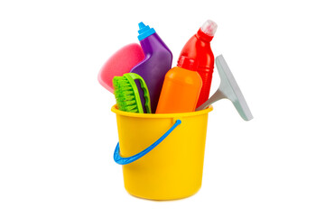 Cleaning items in a bucket isolated on a white background. Cleaning products for home cleaning isolated.Cleaning concept.Close-up. Household chemicals.detergents in plastic bottles, sponges and gloves