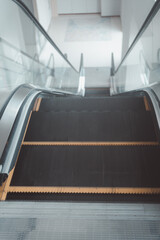 Close up to escalator yellow and black steel line in shopping mall