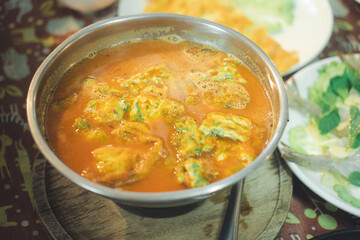 Acacia omelets in vegetable sour soup at restaurant. Traditional Thai style. Close up