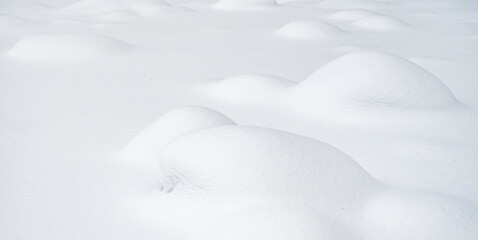 Snowy landscape with rounded hills, smooth texture and untouched snow. Concept for design and...