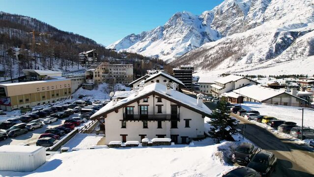 Panoramic aerial drone scenic view at ski slopes, mountain skiing and popular resort town. Italian ski resort in Alps in Aosta Valley in winter. Winter landscape. Italy, Breuil Cervinia. 4K video.
