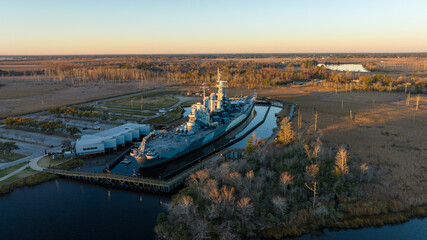 Battleship at sunrise in Wilmington, North Carolina, with the Cape Fear River flowing on the left...