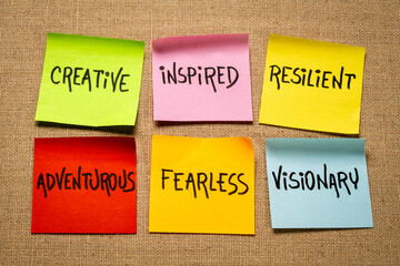 inspirational power words - creative, inspired, resilient, adventurous, fearless and visionary - set of sticky reminder notes against burlap canvas