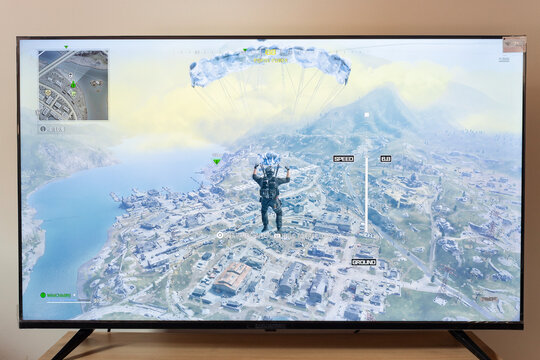 Warzone call of duty 2023 edition battle royal operator flying in a parachute over urzikistan map in an android smart tv 