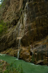 Russia. North Caucasus, Kabardino-Balkaria. A picturesque low-water waterfall among mossy rocks in the Chegem gorge.