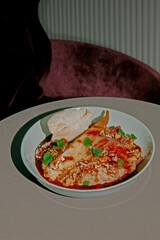 Healthy breakfast. Oat porridge, muesli with pear, honey, red berry jam in a ceramic bowl. Served on table in restaurant, cafe. Morning breakfast concept, banner. Diet Nutrition Concept