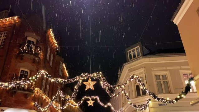  Decorated for Christmas holidays, Denmark, Copenhagen , Viborg, Shopping street in historical center of Aarhus decorated for New Year holidays, Pedestrians Christmas shopping on Stroget at night.