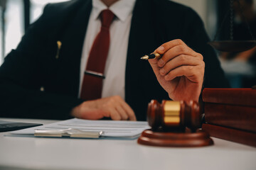 Business and lawyers discussing contract papers with brass scale on desk in office. Law, legal...