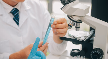 Scientist or medical in lab coat working in biotechnological laboratory, Microscope equipment for...