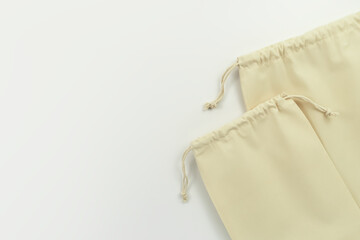 two empty cotton bags on a white background. eco friendly storage concept