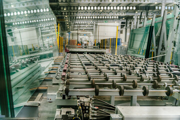 Glass cutting machine at interior of a large glass and mirror cutting factory.