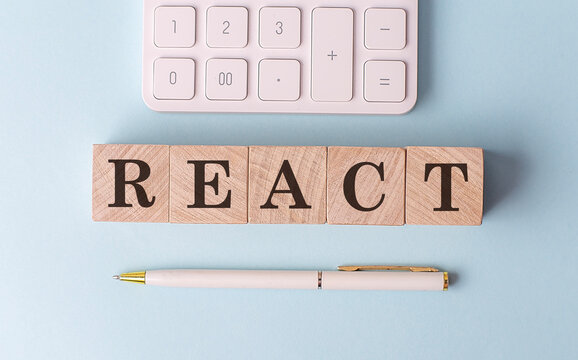 REACT on wooden cubes with pen and calculator, financial concept