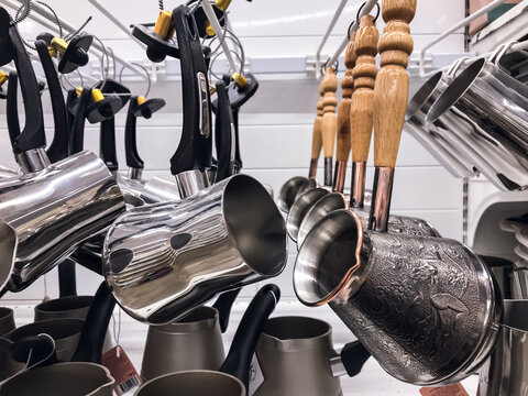 Cezve pot Coffee Brewing , pot steel with wooden handle, hanging on store shelf tableware. concept coffee cooking
