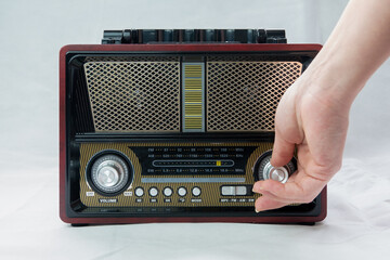 A Female Fingers Tuning the Frequency on an Old Vintage Analog Receiver. Search for a music radio...