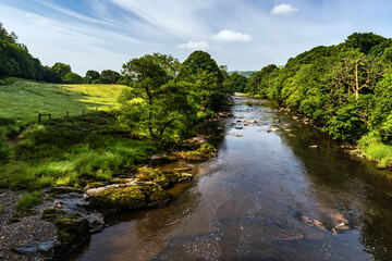 The River Rawthey, taken from the bridge on the A683 just south of the market town of Sedburgh in the Yorkshire Dales. - obrazy, fototapety, plakaty