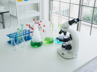 scientific instruments beaker test tube and microscope for analyze scientists was placed on white...