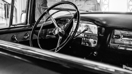 the dashboard of a beautiful 1950s cadillac on display at a car show
