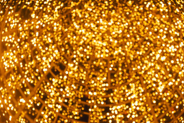 defocused orange and yellow glare garlands, New Year's tree in the city of Lisbon. Christmas lights in Portugal. blurred background.