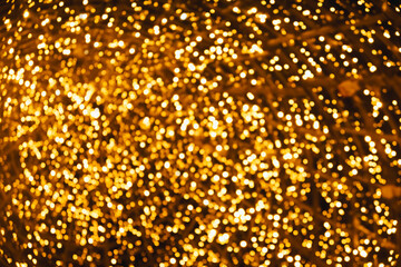 defocused orange and yellow glare garlands, New Year's tree in the city of Lisbon. Christmas lights...