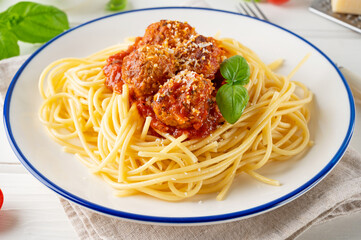 Traditional Italian spaghetti pasta with meatballs, tomato sauce and parmesan cheese, selective focus. Comfort food.