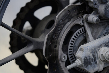 Muddy dirty motorbike rear brake and wheel system