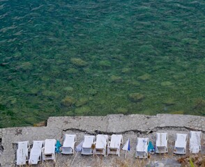 Fototapeta na wymiar Aerial view of deckchairs at beach in Ohrid, Lake Ohrid, North Macedonia.