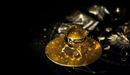 magic crystal ball for predictions close up on dark abstract background. witchcraft ritual with...