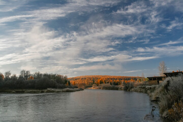Fototapeta na wymiar Autumn landscape on frosty September morning in the upper reaches of tributary of the Lena River.