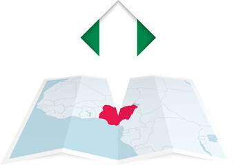 Nigeria pin flag and map on a folded map