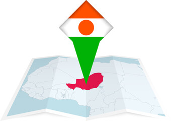 Niger pin flag and map on a folded map